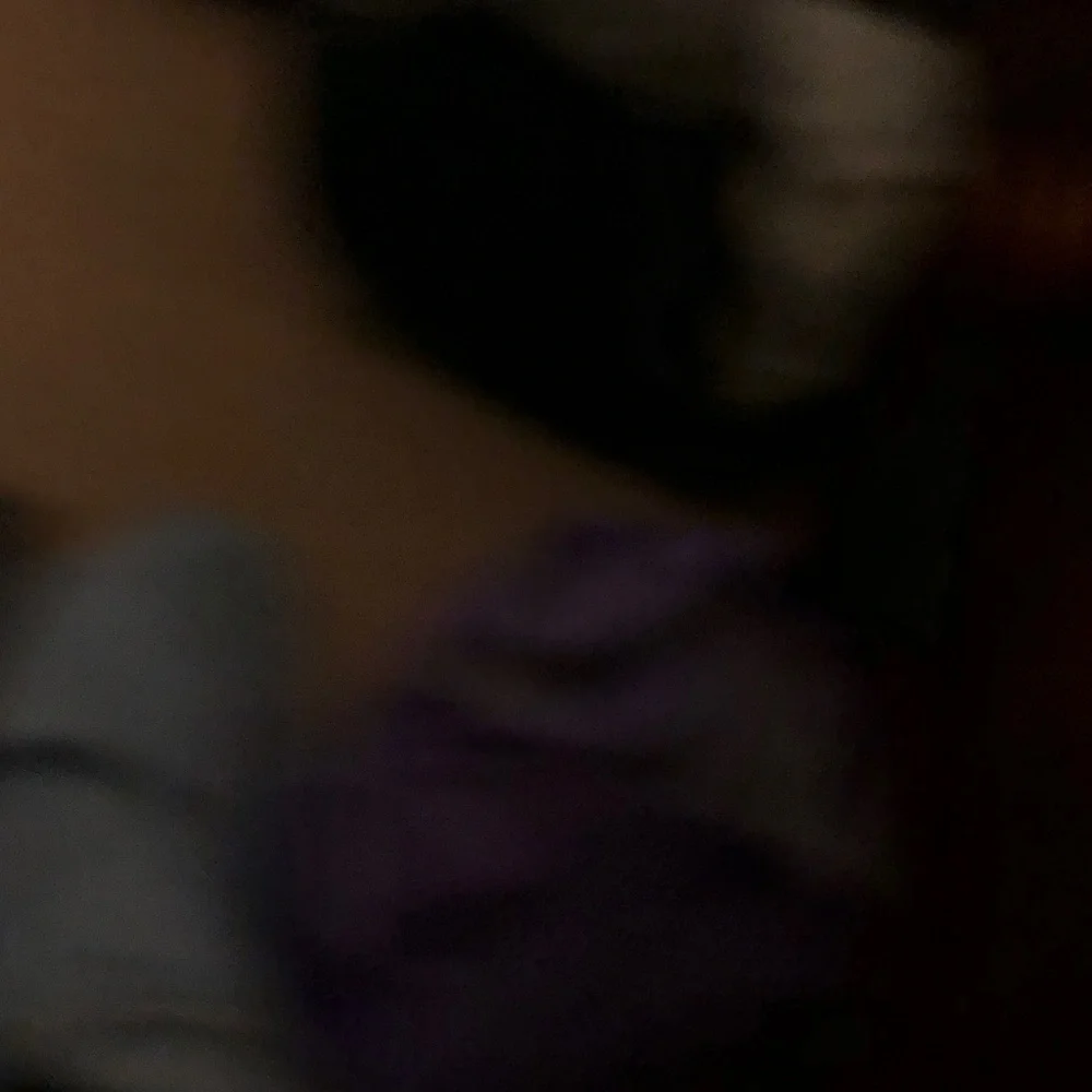 Blurry Black Item with Dark Green and Purple Hues